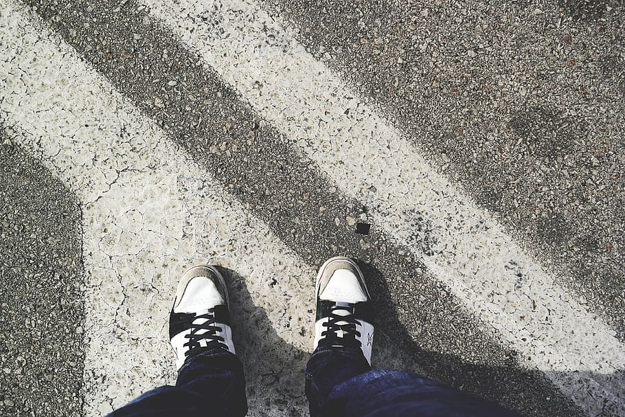 person, wearing, black-and-white, sneaker, standing, road, daytime, white, black, sneakers