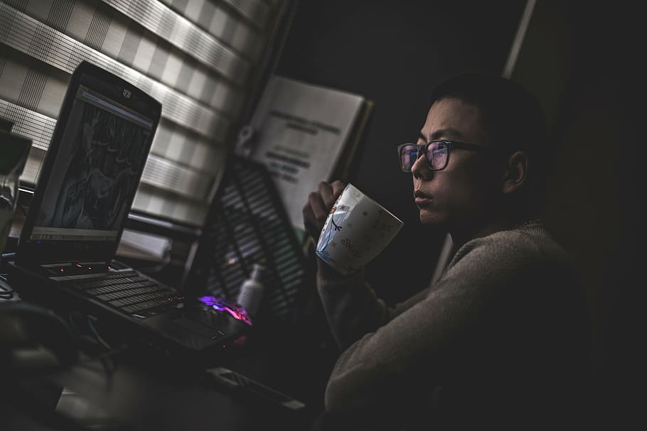 man, holding, cup, looking, laptop, wearing, gray, shirt, white, ceramic