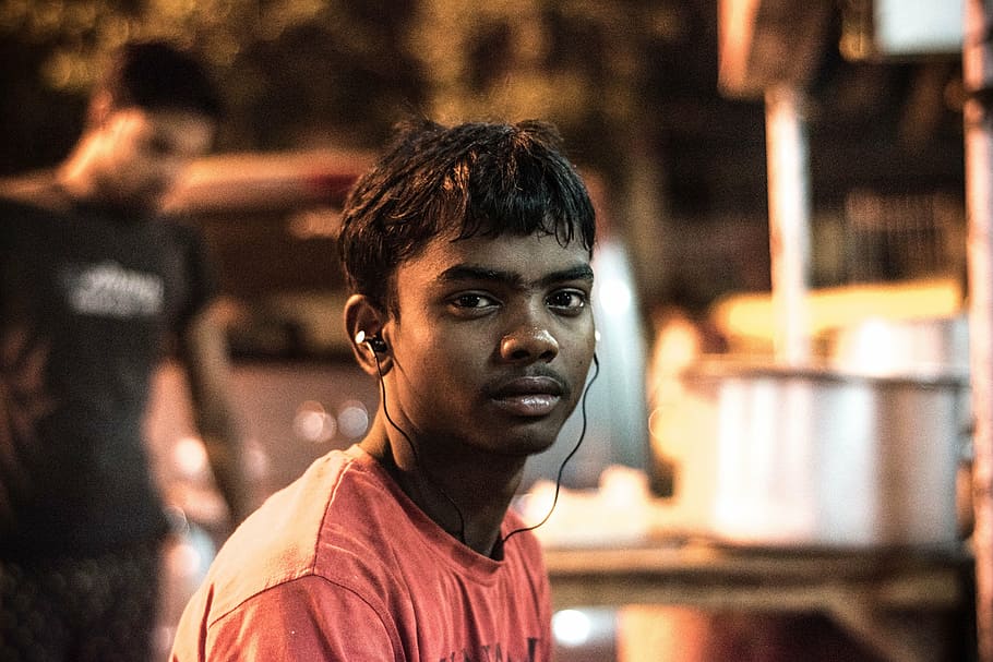 man, listening, earbuds, teenage boy, street hotel boy, boy, young, portrait, focus on foreground, young adult