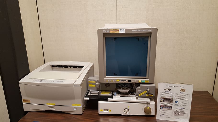 obsolete technology, microfilms, microform, scanner, technology, computer, indoors, computer monitor, table, computer equipment