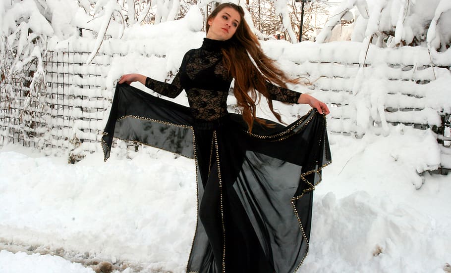woman, wearing, black, abaya dress opening, wide, standing, fence, covered, snow, daytime