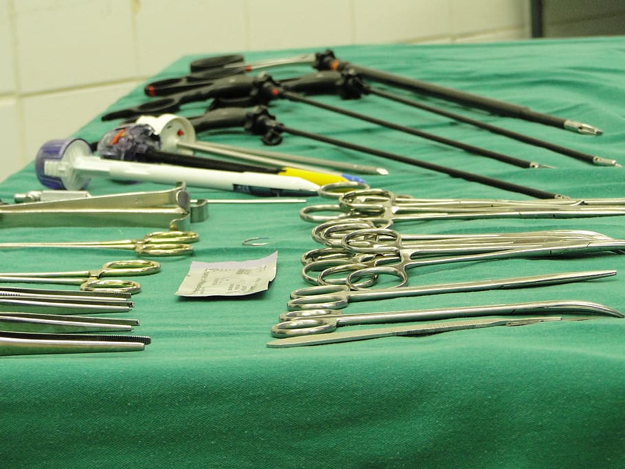 cirurgical instruments, tweezers, surgical clamps, metal, still life, table, indoors, close-up, equipment, green color