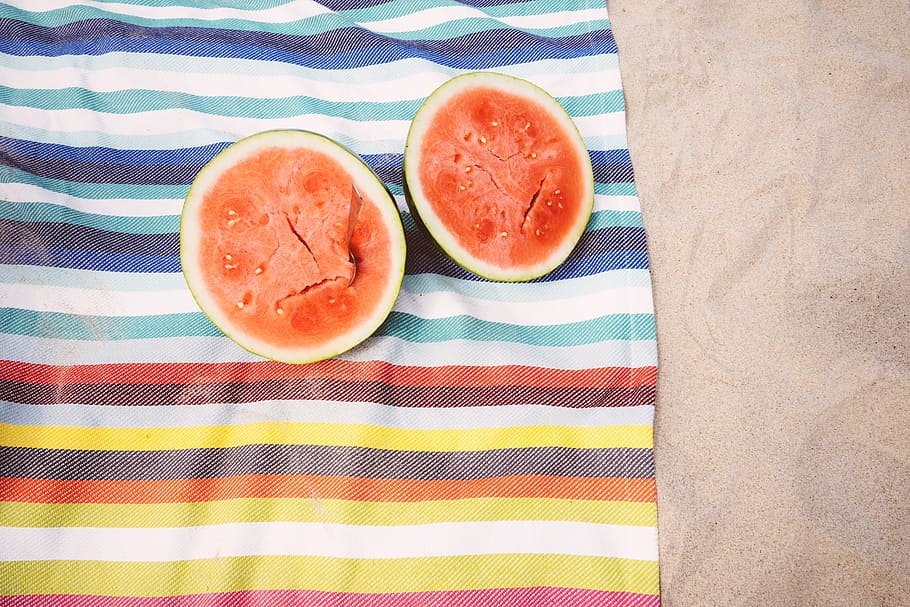 two slice watermelons, beach, blanket, fruit, looking down, sand, summer vibes, summertime, tropical fruit, watermelon