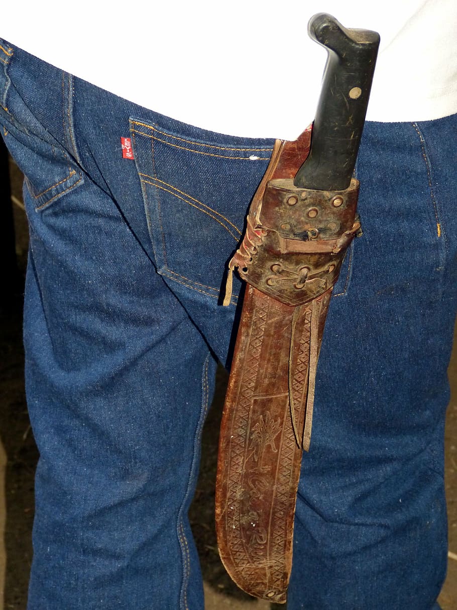person carrying machete, knife, vagina, dagger, bauer, farmer, pants, jeans, blue jeans, costa rica
