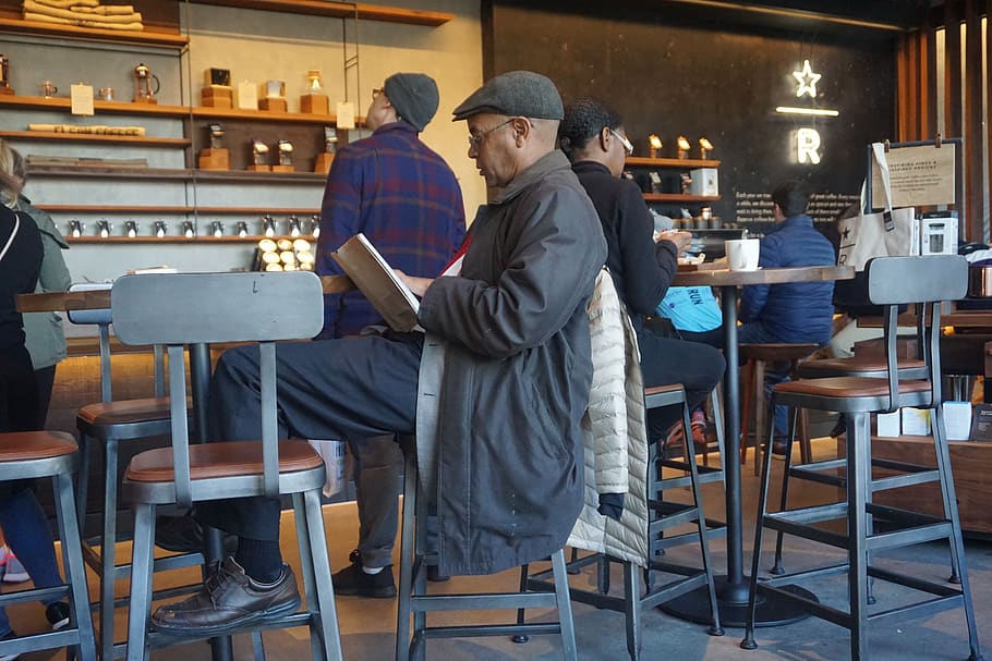 black man, man, reading, book starbucks, coffee, men, real people, two people, table, chair