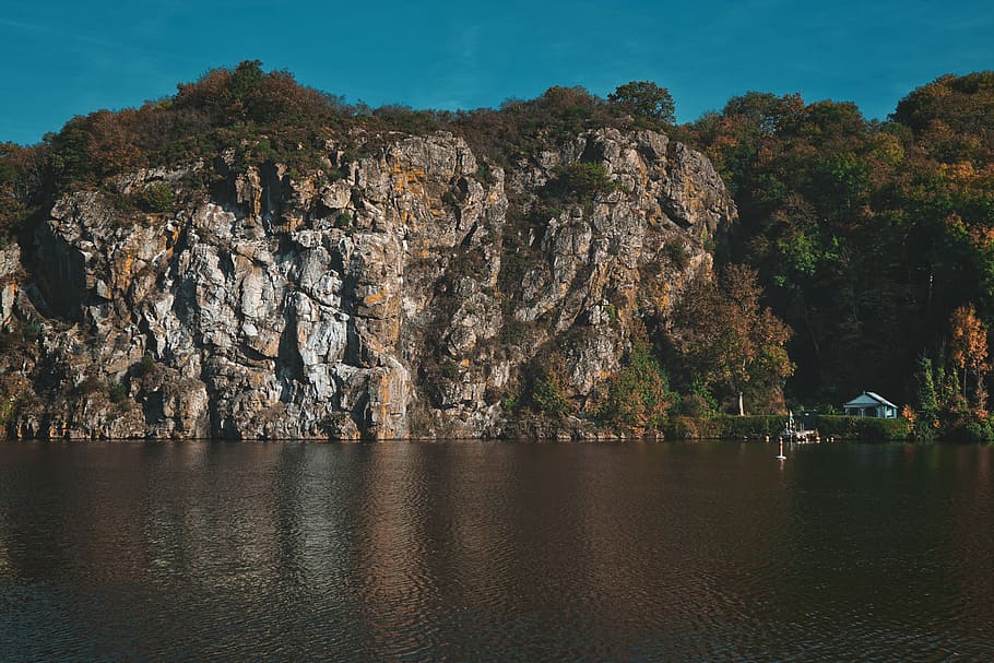 cliff, daytime, landscape, rock, formation, near, white, house, front, water
