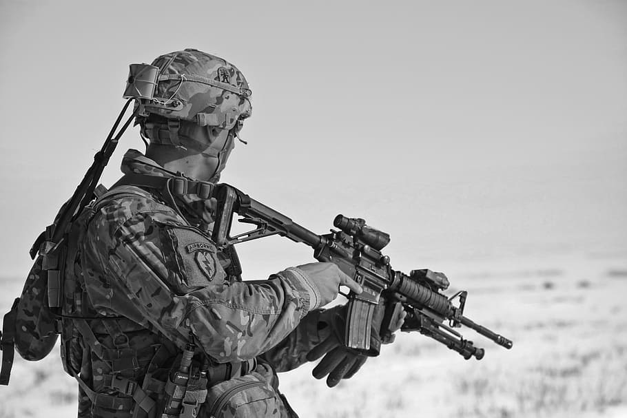 grayscale photo, soldier, holding, sniper rifle, uniform, army, weapon, bullets, projectile, war