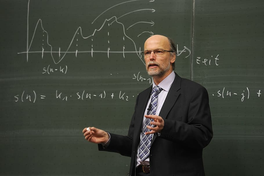man, wearing, black, suit jacket, birger kollmeier, professor, blackboard, physics, lecturer, university