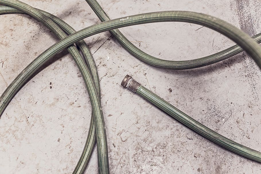 garden hose, high angle view, metal, transportation, day, mode of transportation, cable, nature, curve, track