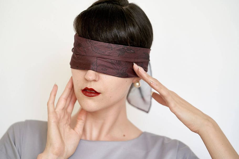 Blindfold, blind-folded woman, headshot, portrait, one person, studio shot, front view, young adult, indoors, white background
