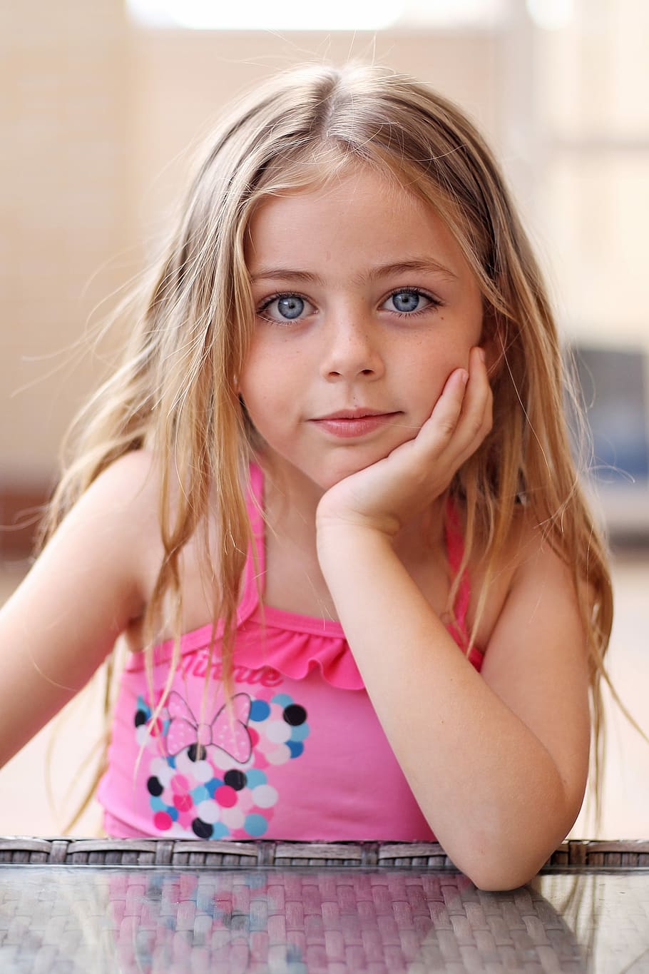 girl, sitting, table, putting, hand, chin, children, smile, eyes, happy