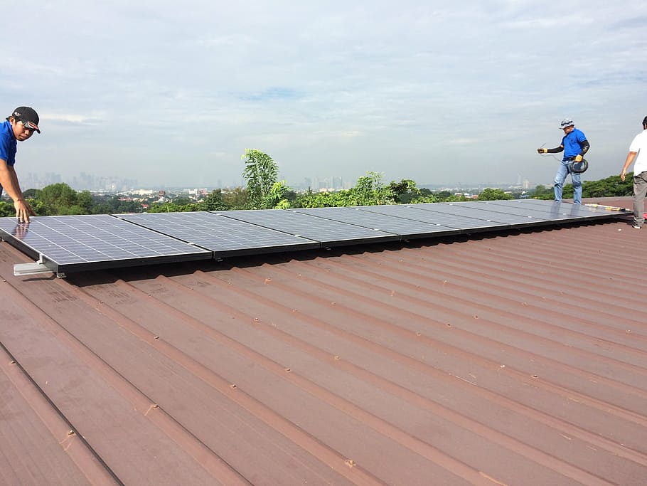 several, men, installing, rectangular, black, solar, panel, top, brown, roof