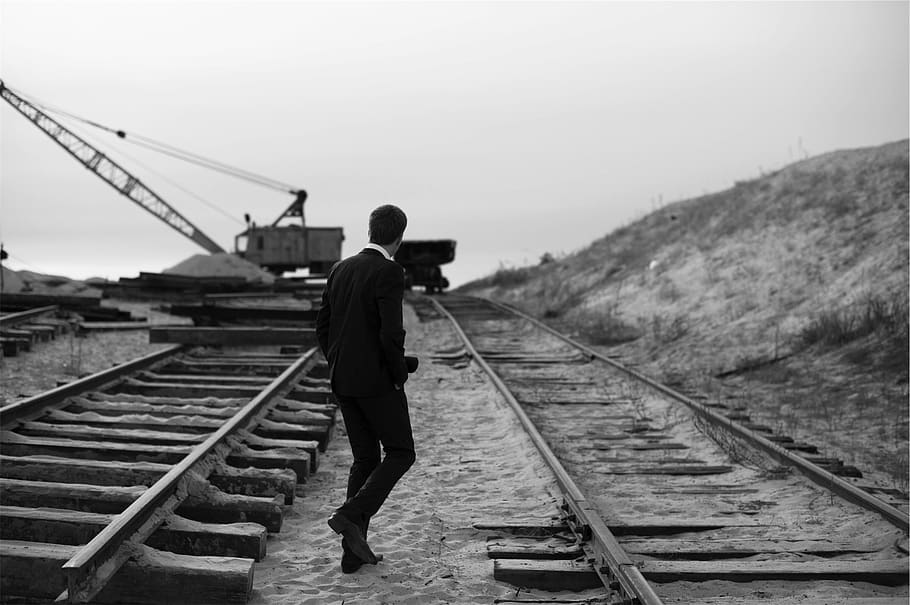 guy, man, suit, railway, railroad, train tracks, sand, crane, black and white, people