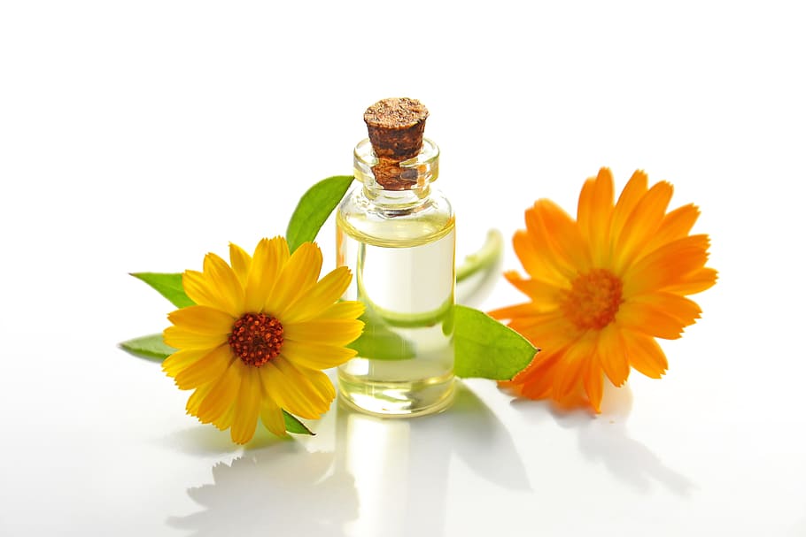 clear, glass jar, yellow, orange, petaled flowers, essential oil, cosmetology, spa, cosmetic oil, natural product