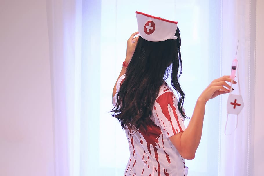 woman, white, nurse costume, holding, syringe, mask, facing, towards, curtain, woman in white