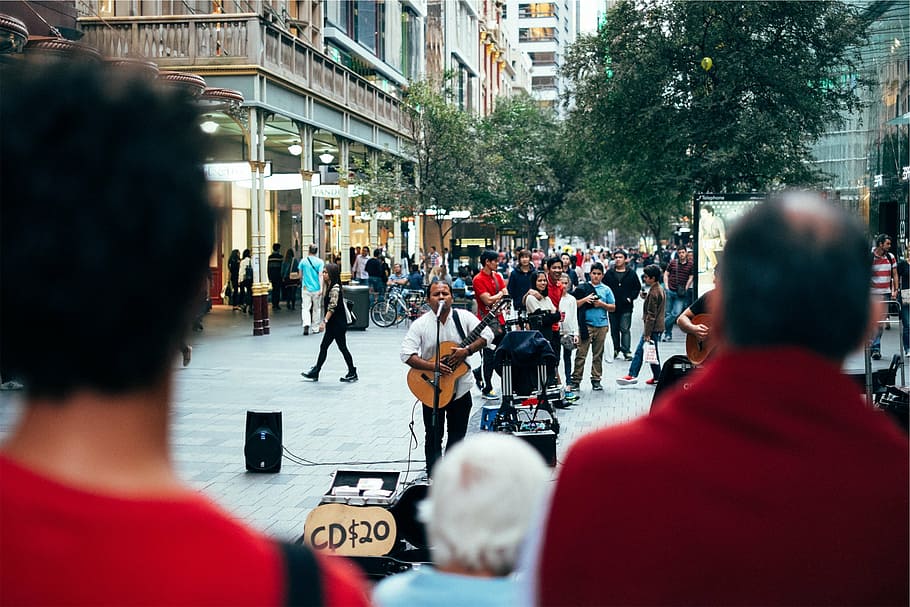 man, holding, acoustic, guitar, singing, street, surrounded, people, close, white