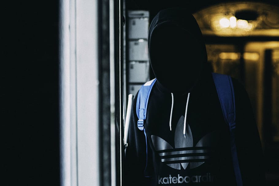 person, wearing, black, gray, adidas pullover hoodie, blue, backpack, standing, clear, glass panel