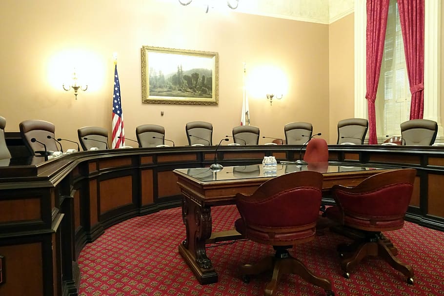 two, brown, wooden, rolling, armchairs, front, desk, committee room, meeting, capitol
