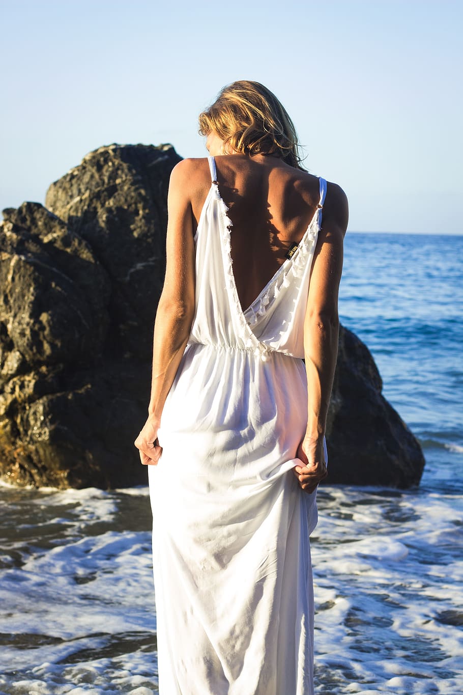 woman, wearing, white, dress, facing, sea, rock formation, girl, back, long dress