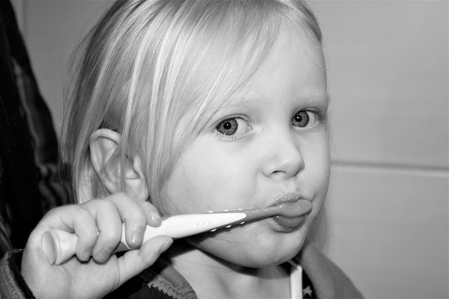 girl, holding, toothbrush grayscale photo, brushing teeth, tooth, child, zahnarztpraxis, dental care, zahnreinigung, dental hygiene
