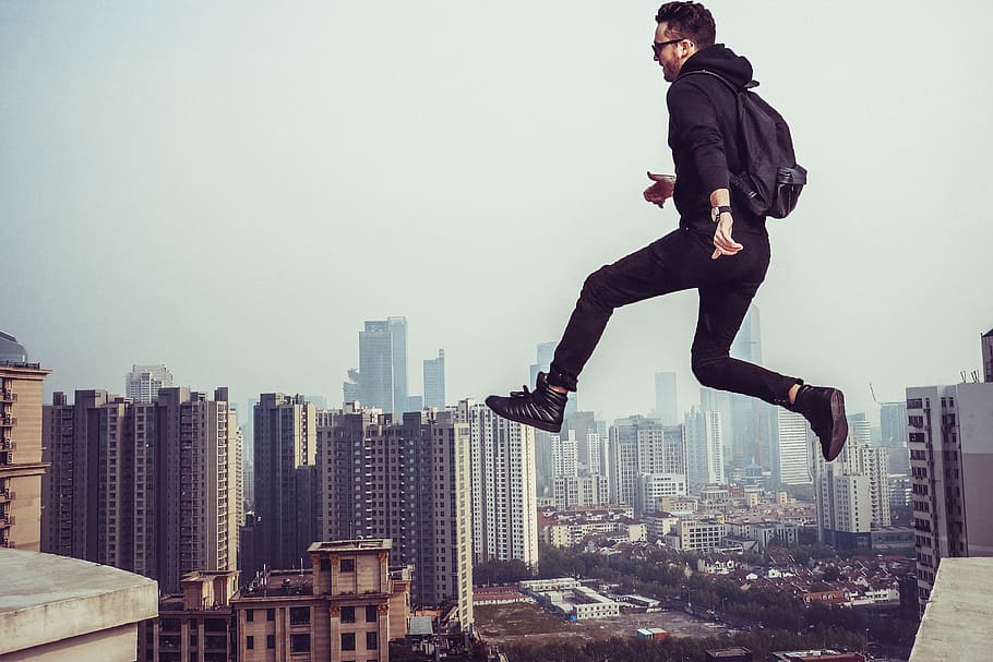 people, man, jumping, flying, sky, aerial, fog, building, roof, infrastructure