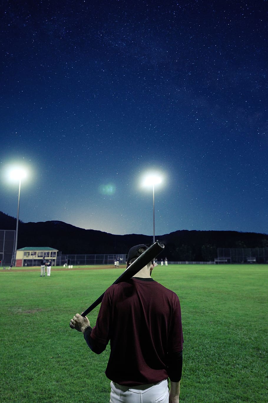 man, holding, baseball bat, baseball field, nighttime, baseball, player, stadium, field, arena