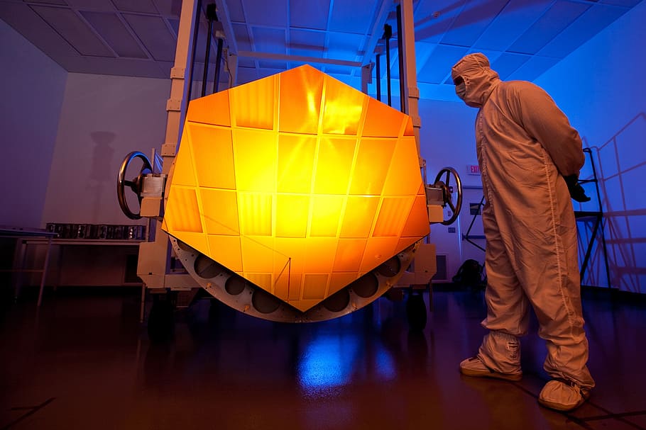 man, wearing, gray, suit, standing, hexagonal, orange, panel, space telescope, telescope