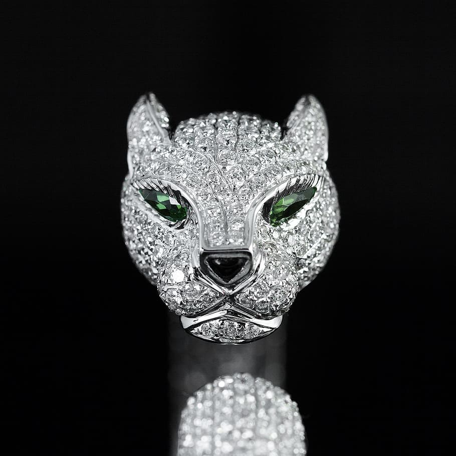 silver-colored, clear, gemstone, encrusted, cat pendant, cartier, panther head, diamond, bracelet, black background