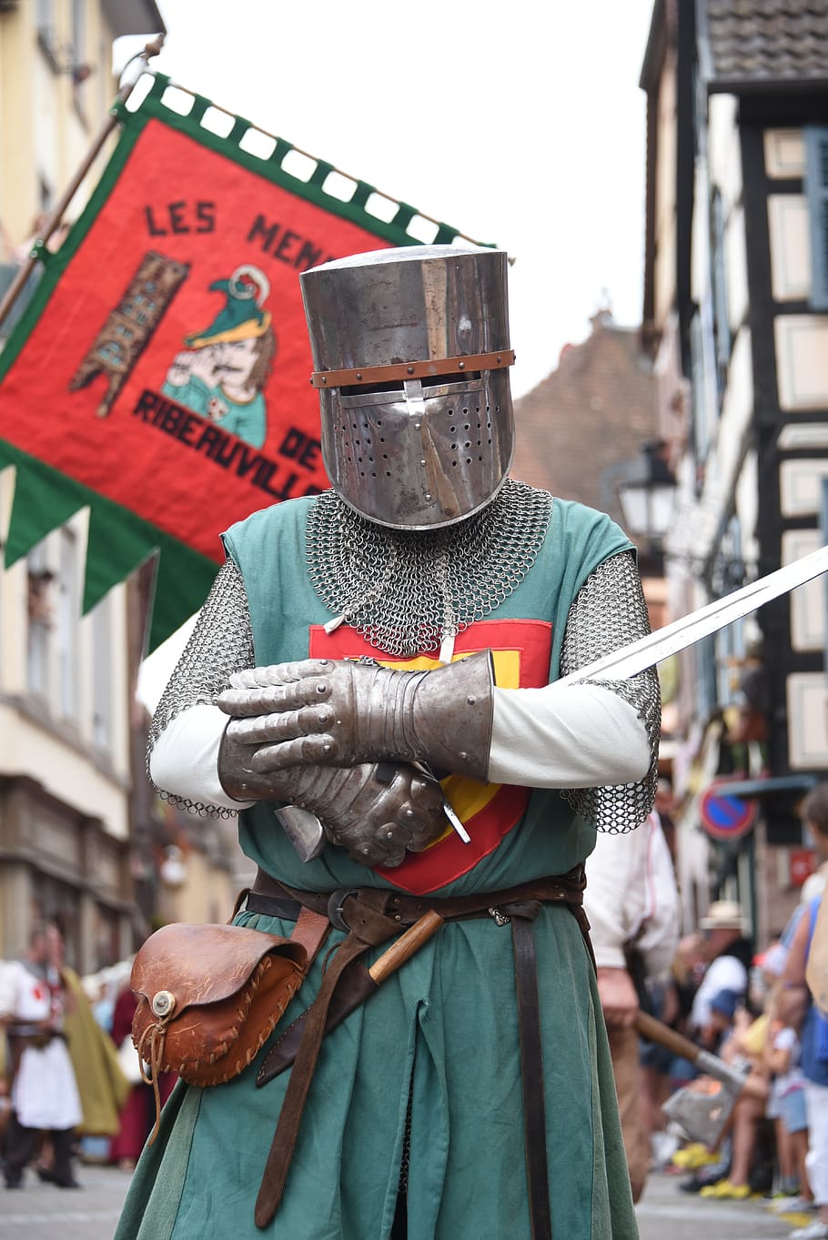 knight, medieval, armor, sword, focus on foreground, incidental people, day, real people, one person, holding