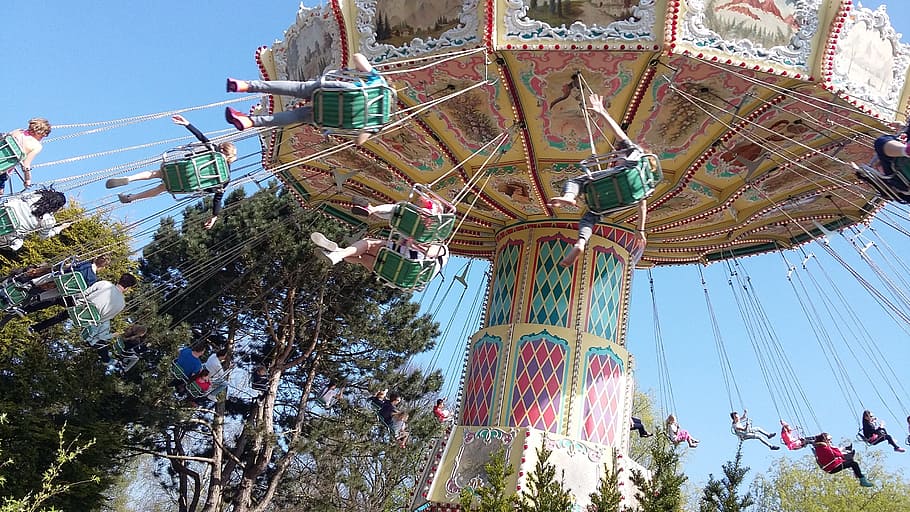 carousel, theme, funfair, amusement park, amusement park ride, arts culture and entertainment, tree, low angle view, sky, group of people
