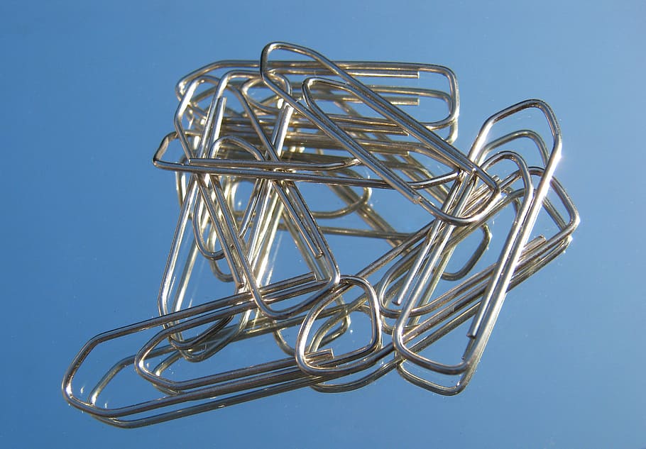 office, paper clips, several, metal, low angle view, blue, sky, still life, studio shot, close-up