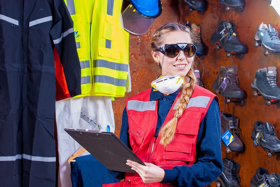 woman, wearing, red, vest, holding, clip board, industrial, security, logistic, work clothes