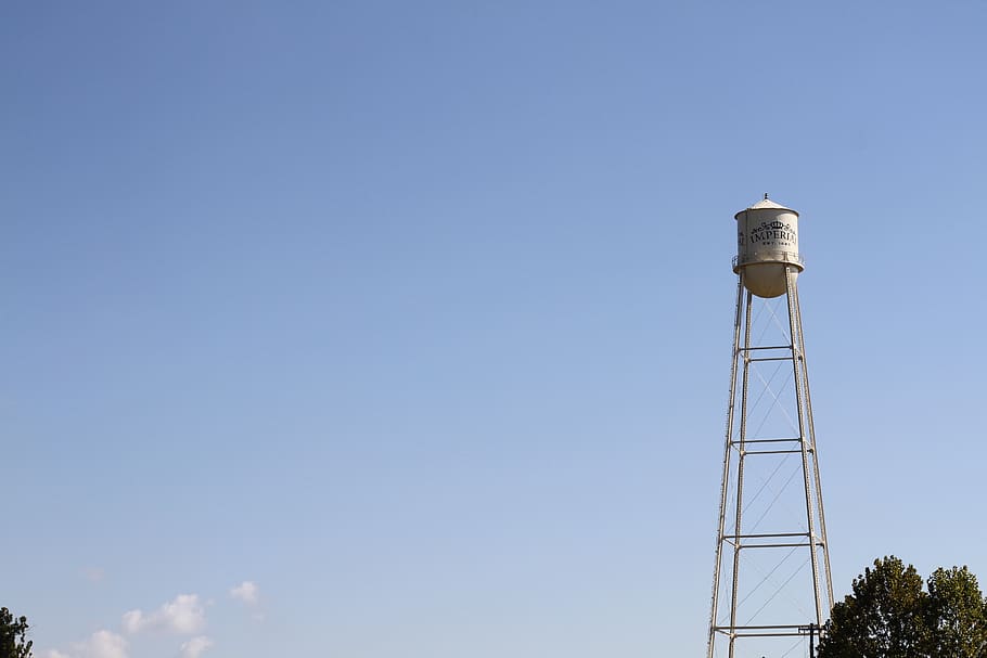 water tower, small texas city, next to sugar factory, tower, blue, sky, copy space, built structure, day, architecture