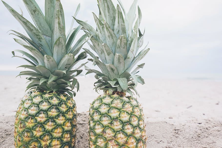 two pineapple fruits, beach, fruit, pineapple, sand, summer, summer vibes, summertime, tropical, tropical fruit