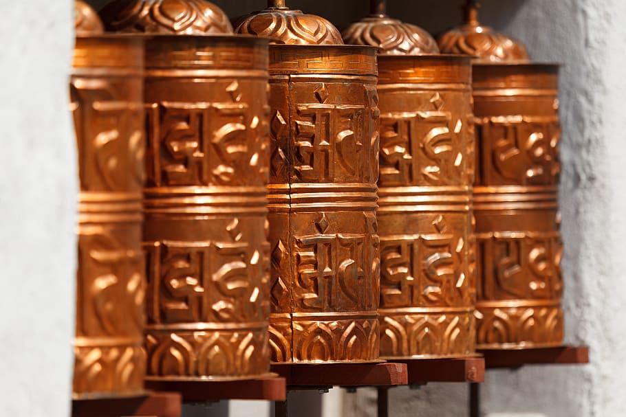 copper-color canisters, asia, buddhism, culture, faith, holy, nepal, pray, prayer wheels, religion