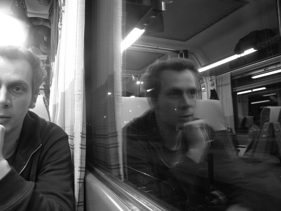 talking about, man, train, window, comment on, reflection, lifestyles, real people, glass - material, illuminated