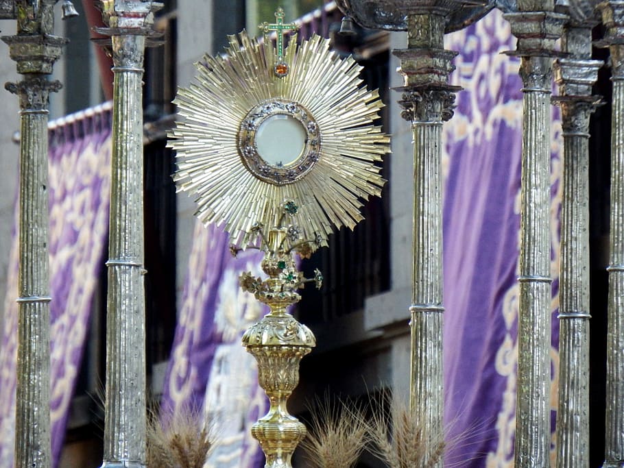 eucharist, monstrance, procession, hanging, purple, indoors, decoration, lighting equipment, architecture, close-up