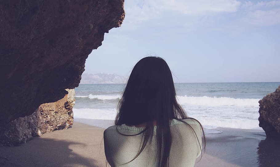 woman, standing, rock, seashore, green, top, daytime, girl, long hair, brunette