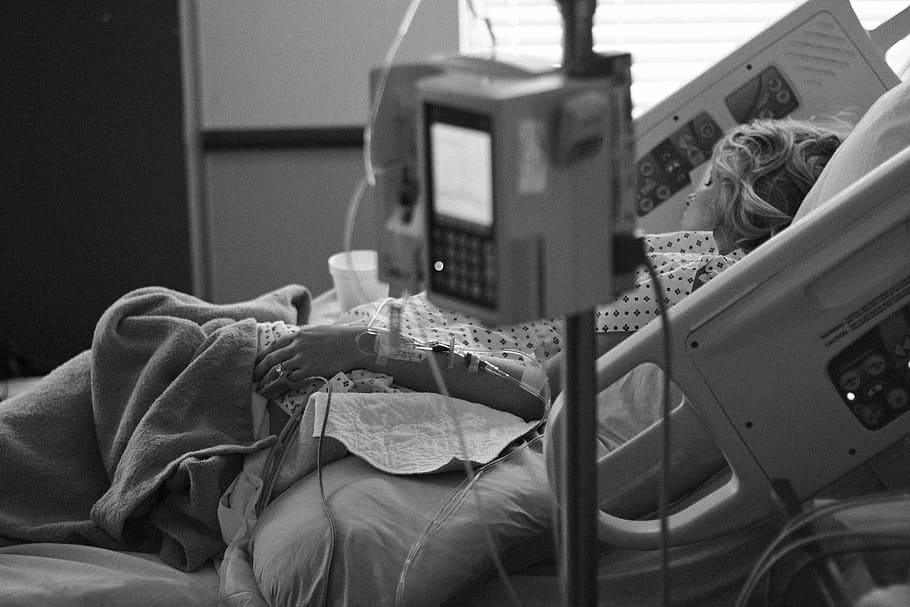 greyscale photo, person, lying, hospital bed, doctor, delivery, labor, medicine, occupation, woman