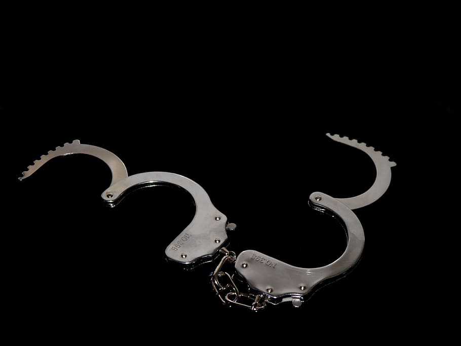 handcuffs, 8, black silver, caught, metal, steel, chain, studio shot, black background, indoors