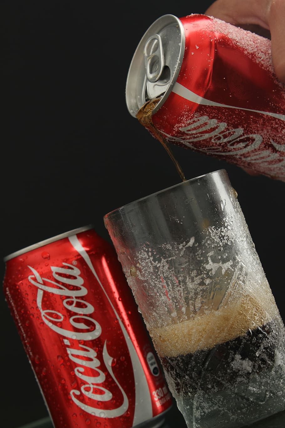 person, pouring, coca-cola soda, highball glass, drink, coca cola, can, red, food and drink, black background