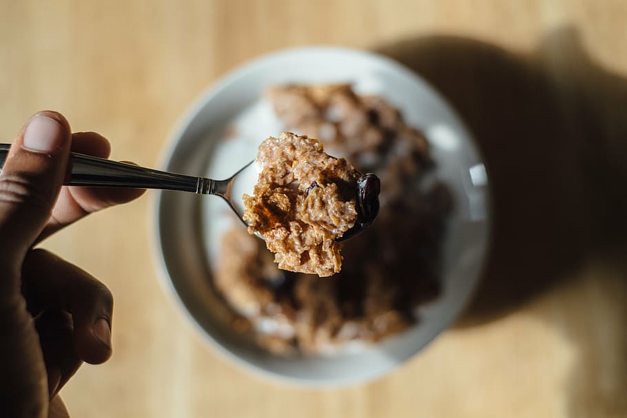 cereal with milk, silver, spoon, held, human, cereal, food, breakfast, morning, bowl