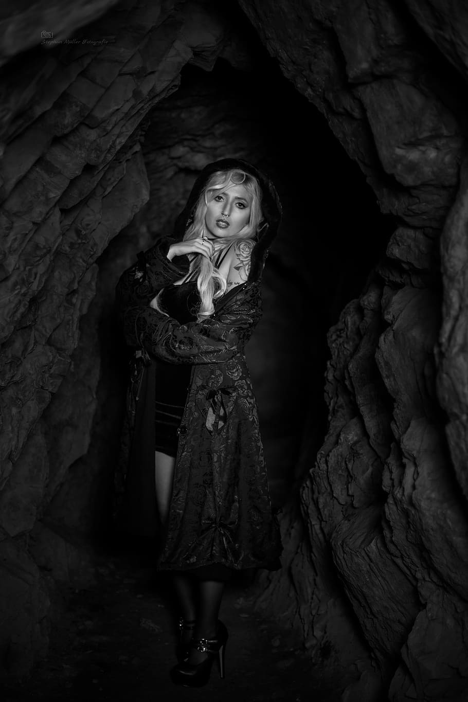 grayscale photography, woman, wearing, robe, inside, cave, tattoo, rock, castle, cliff