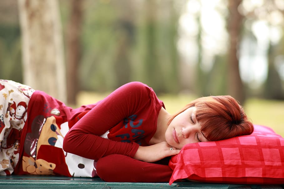 woman, red, sweatshirt, sleeping, outdoor, daytime, sleep, pillow, sleepwalking, portrait