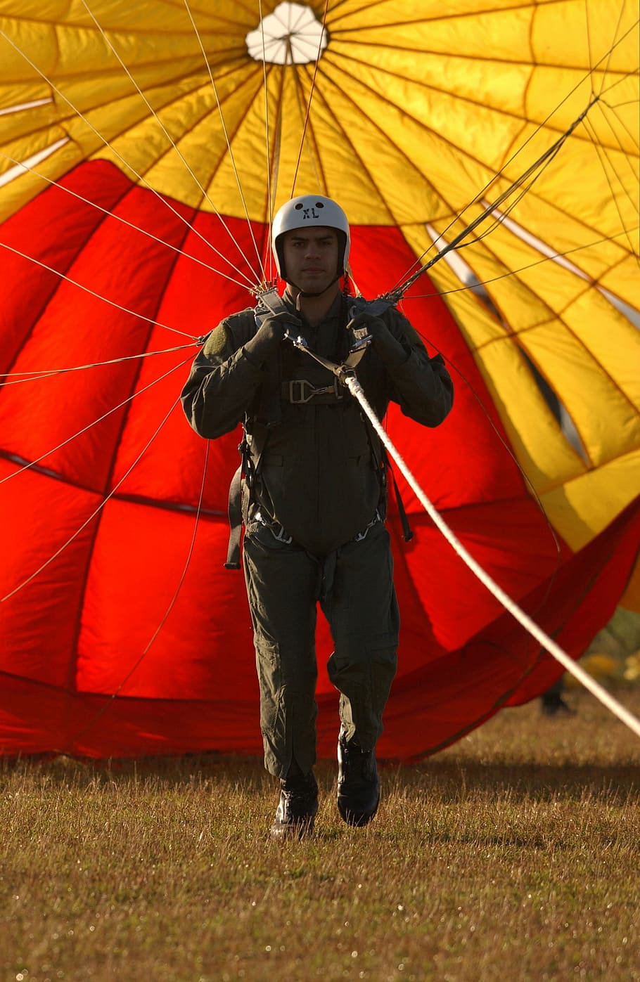 man, wearing, black, overall, pants, white, half helmet, using, parachute, parachutist