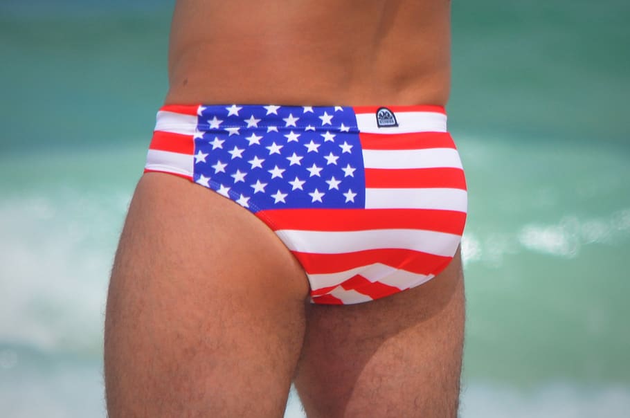 swimming trunks, usa, stars and stripes, sea, united states of america, american flag, one person, midsection, flag, human body part
