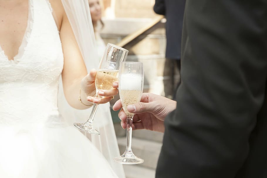 man, woman, holding, glass, champagne, champagne toss, bride, groom, midsection, human hand