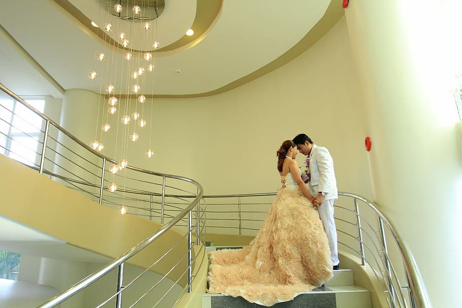 man, woman, standing, staircase, chandelier, wedding, hotel, luxury, white, decoration