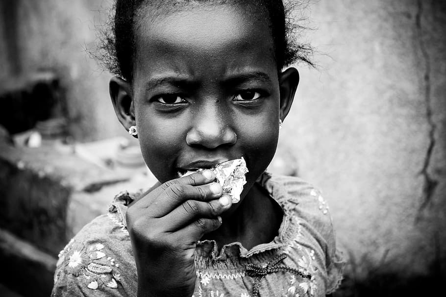 grayscale photo, girl, eating, food, african child, joy, deep look, ask snack, child, childhood