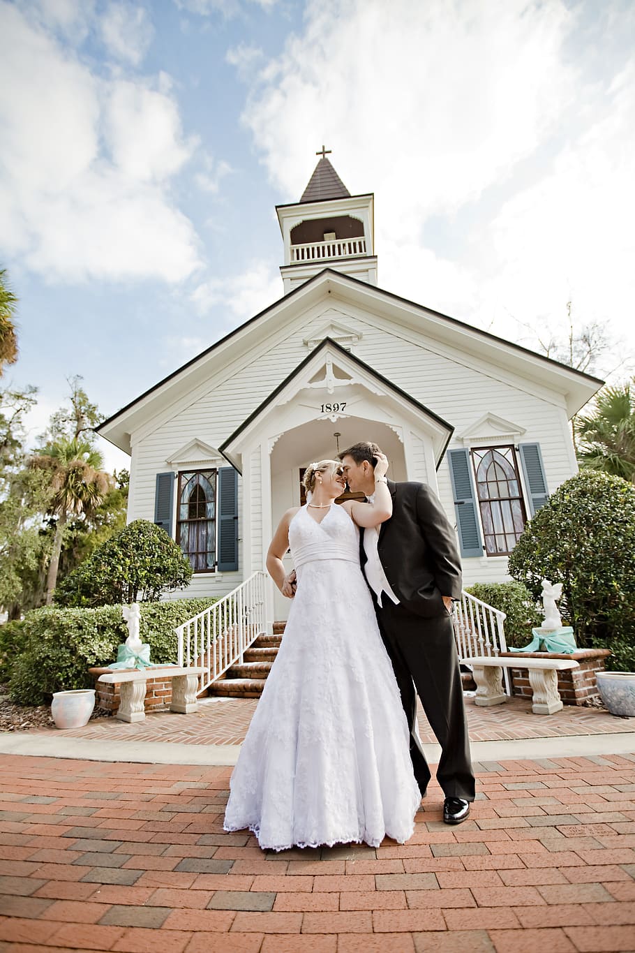 married, couple, front, white, brown, wooden, church, daytime, married couple, wooden church
